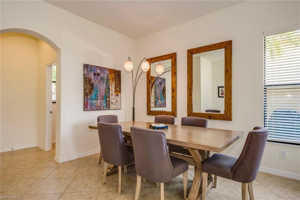 1308 Kendari Terrace Naples, FL 34113 - Photo 8 of 21 Dining space with arched walkways and light tile patterned flooring
