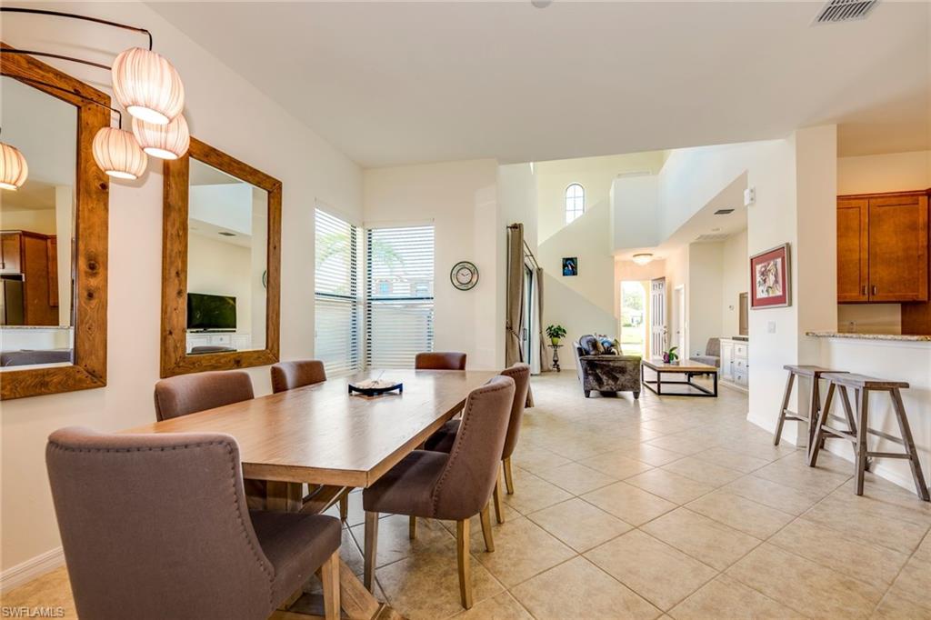 1308 Kendari Terrace Naples, FL 34113 - Photo 9 of 21 Dining area featuring healthy amount of natural light and light tile patterned floors