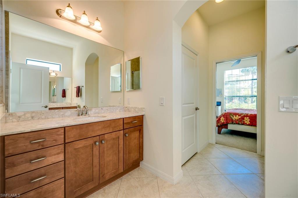 1308 Kendari Terrace Naples, FL 34113 - Photo 10 of 21 Ensuite bathroom featuring healthy amount of natural light, vanity, and light tile patterned flooring