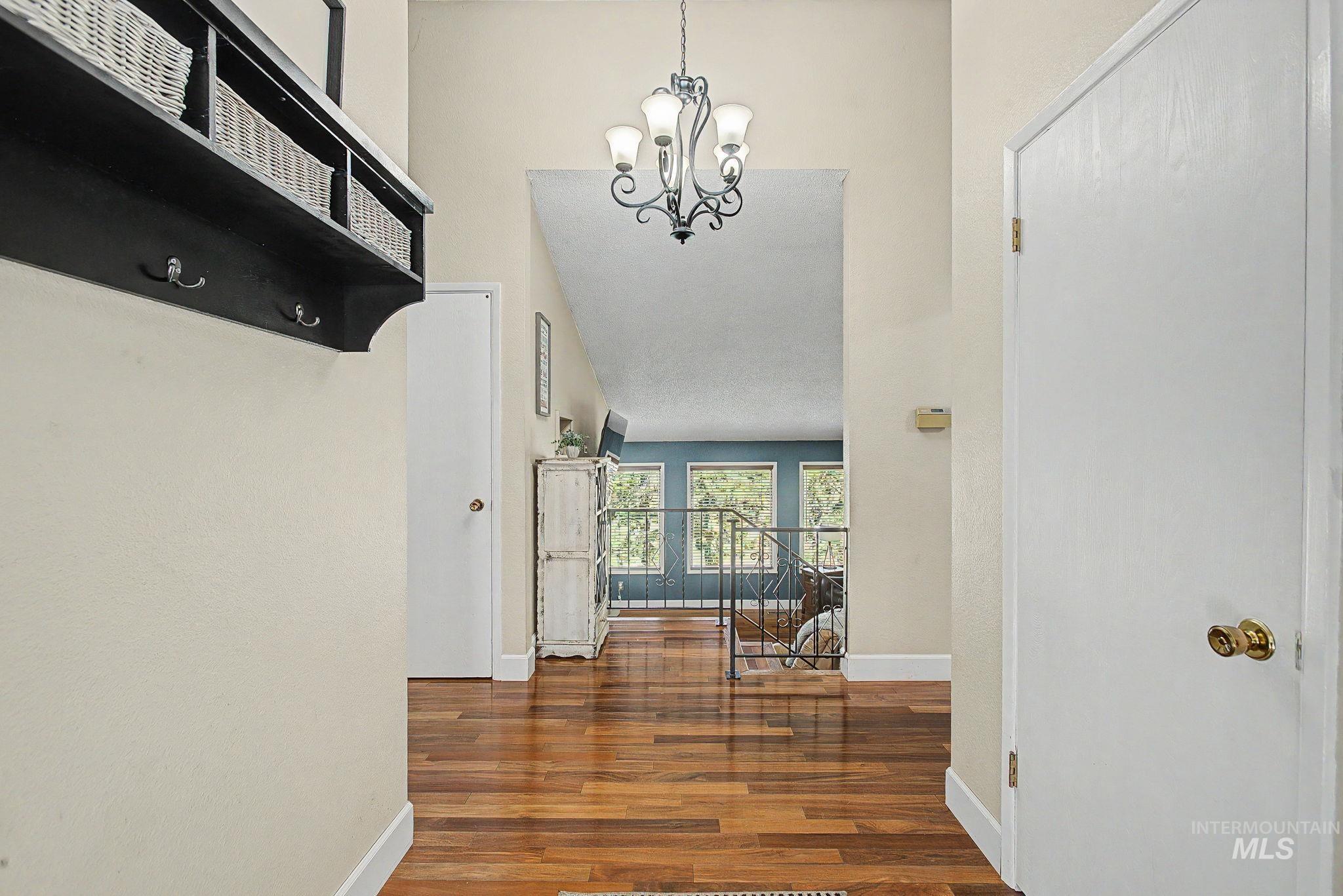 501 Karin Avenue Lewiston, ID 83501 - Photo 11 of 50 Hall with wood finished floors, a high ceiling, and suspended lighting