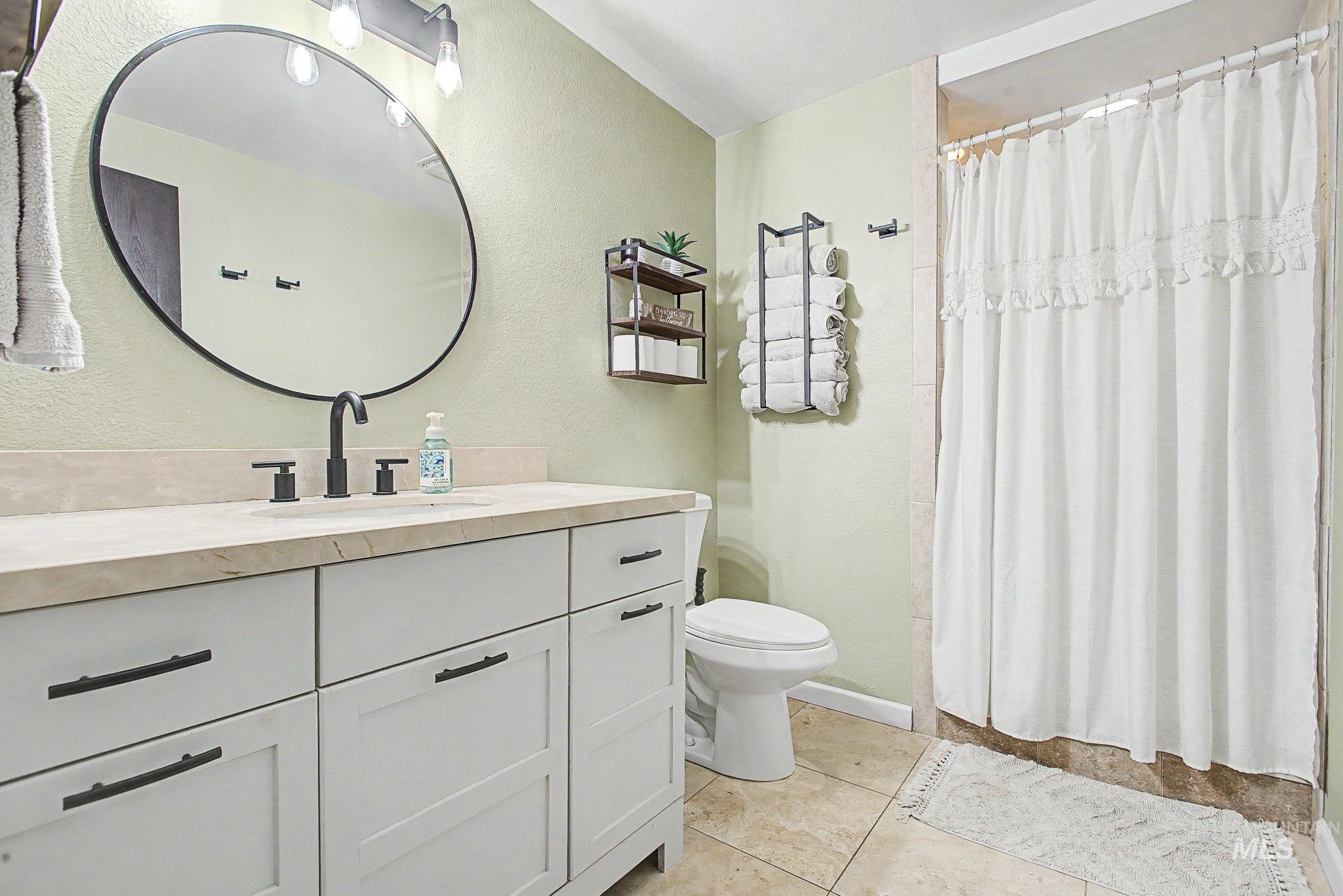501 Karin Avenue Lewiston, ID 83501 - Photo 14 of 50 Bathroom with a shower with curtain, vanity, a textured wall, and light tile patterned flooring