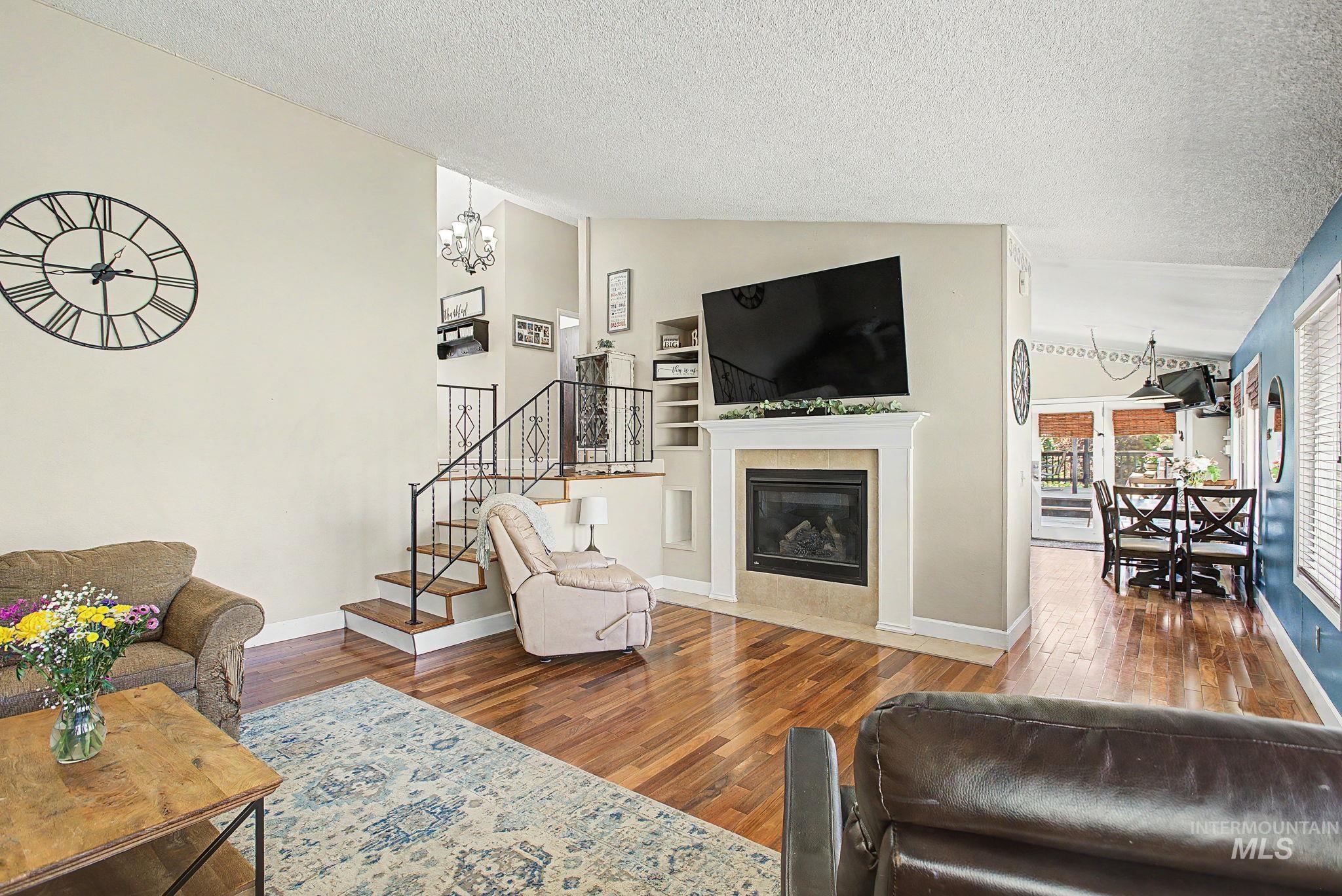 501 Karin Avenue Lewiston, ID 83501 - Photo 18 of 50 Living room with hanging lights, wood-type flooring, and a fireplace with flush hearth