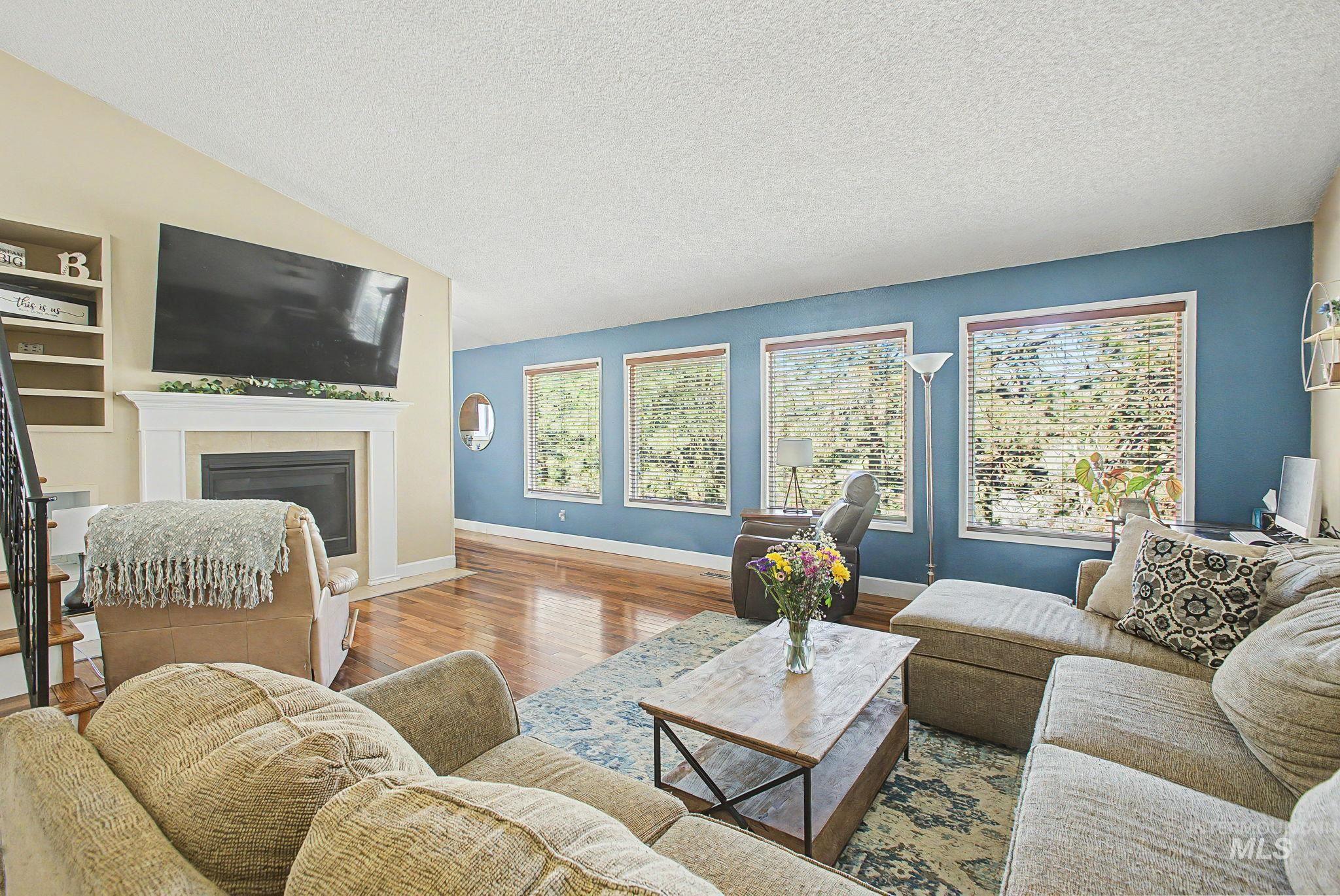 501 Karin Avenue Lewiston, ID 83501 - Photo 19 of 50 Living area with a glass covered fireplace and wood finished floors
