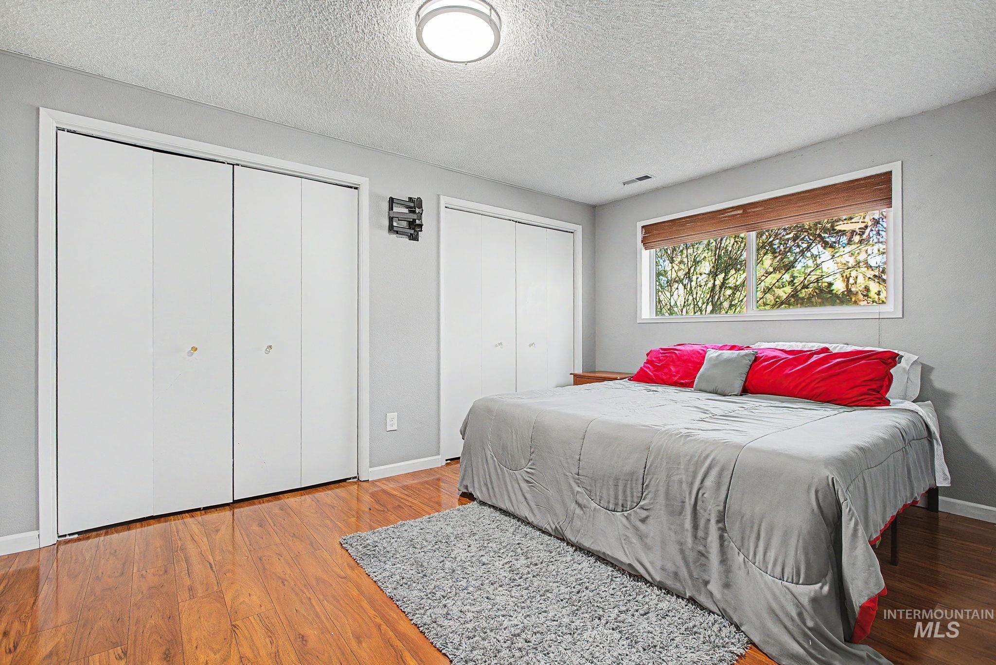 501 Karin Avenue Lewiston, ID 83501 - Photo 36 of 50 Bedroom with two closets, a textured ceiling, and light wood-style flooring