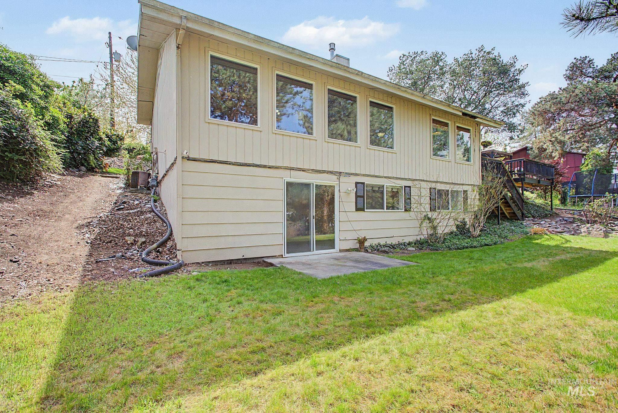 501 Karin Avenue Lewiston, ID 83501 - Photo 39 of 50 Back of house with a patio, a yard, a deck, and a trampoline