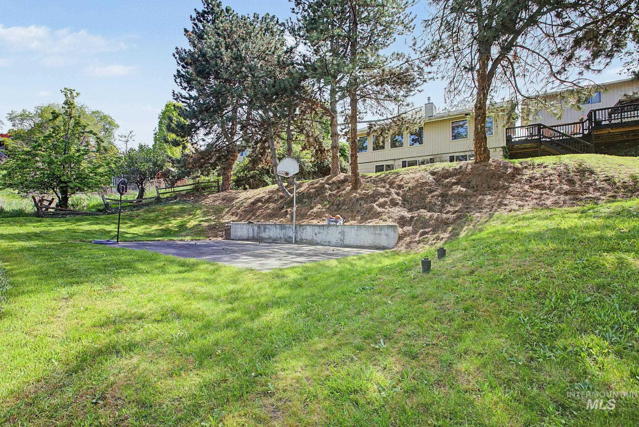 501 Karin Avenue Lewiston, ID 83501 - Photo 44 of 50 View of grassy yard featuring a deck and basketball hoop