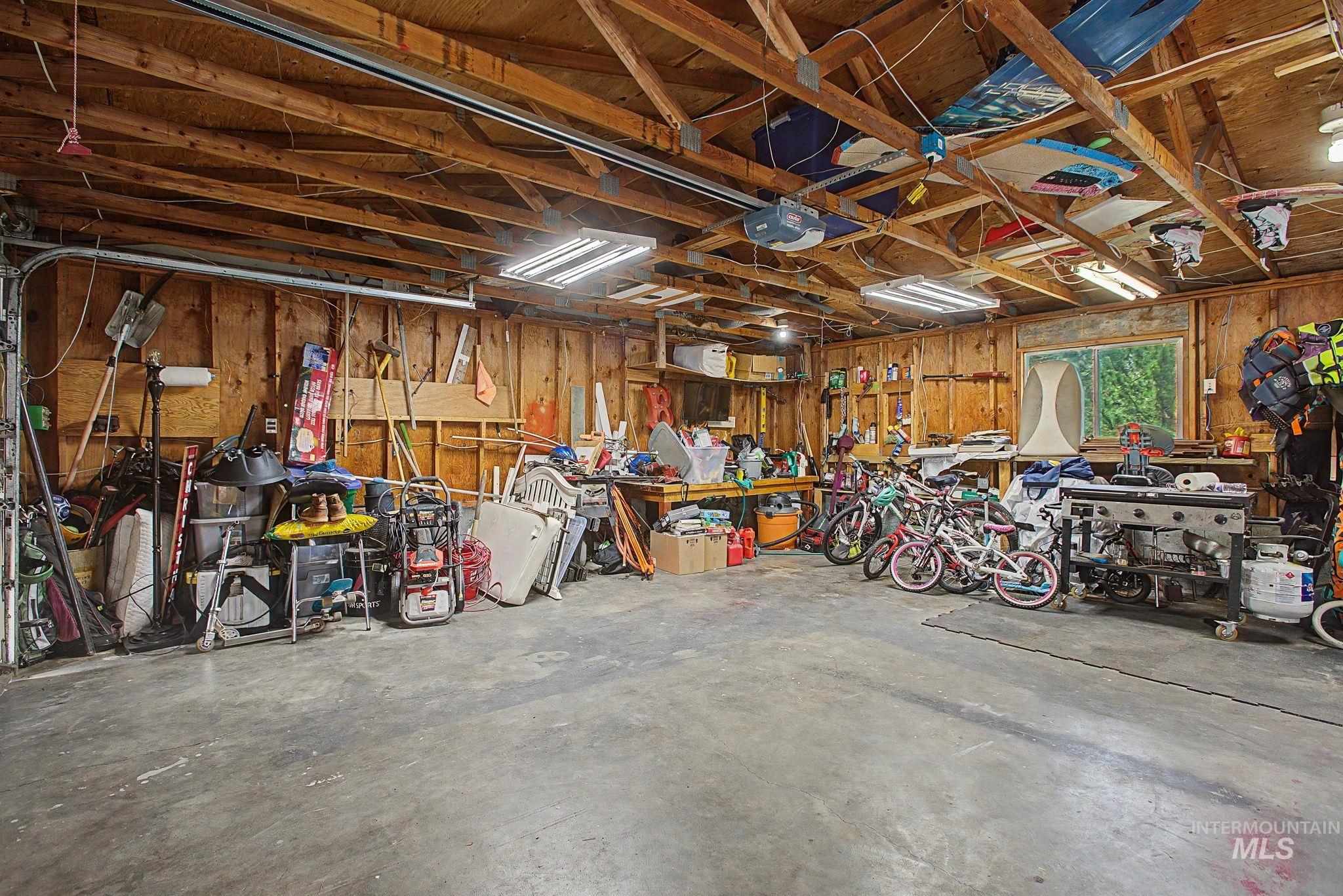 501 Karin Avenue Lewiston, ID 83501 - Photo 47 of 50 Garage featuring wooden walls, a workshop area, and a garage door opener