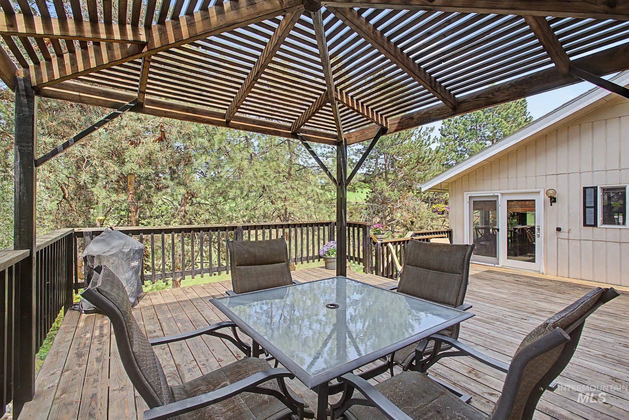501 Karin Avenue Lewiston, ID 83501 - Photo 8 of 50 Wooden terrace featuring outdoor dining space, a grill, and a pergola