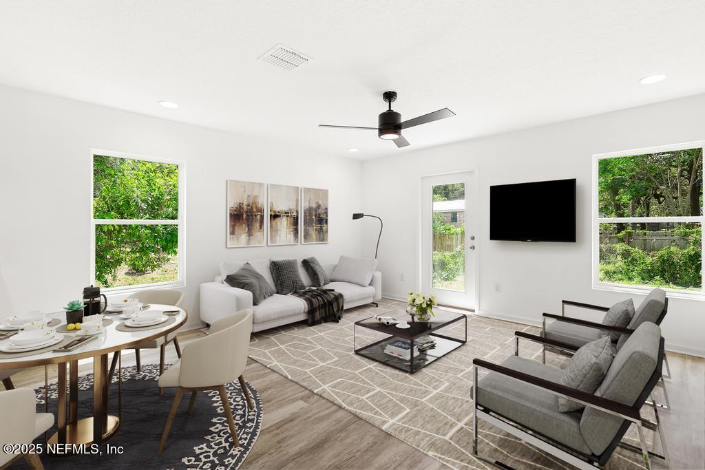 7845 Pipit Avenue Jacksonville, FL 32219 - Photo 15 of 38 a living room with furniture a flat screen tv and a large window