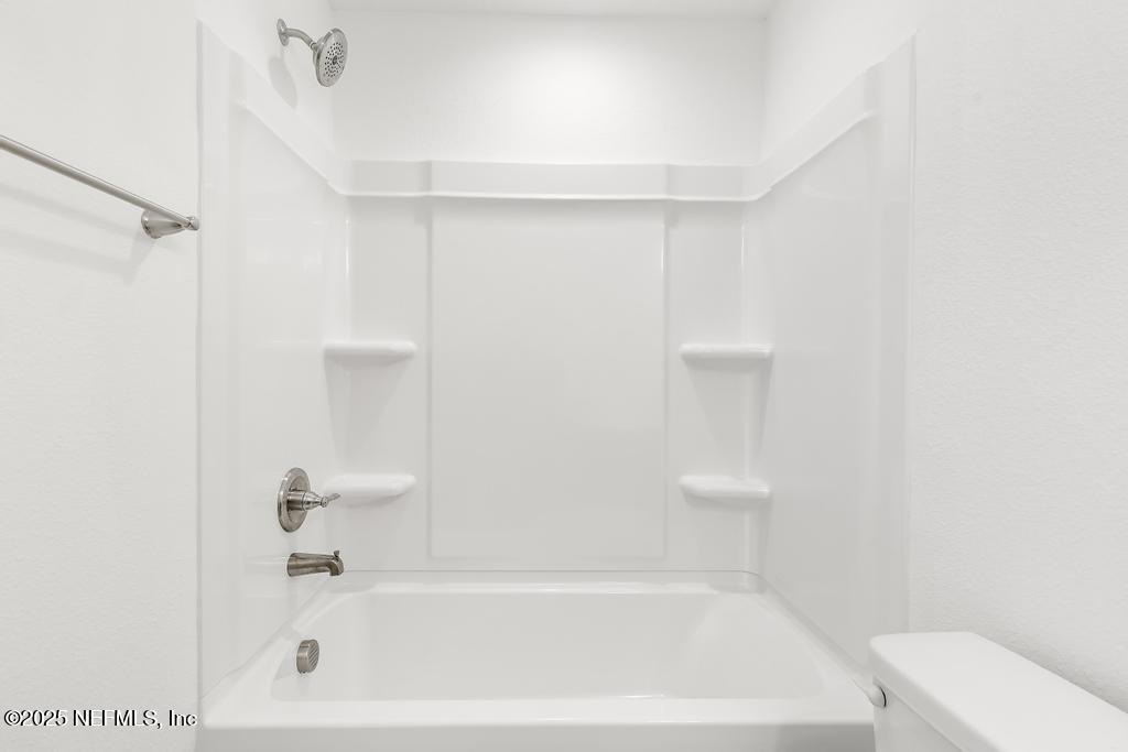 7845 Pipit Avenue Jacksonville, FL 32219 - Photo 21 of 38 a bathroom with a bathtub and a toilet