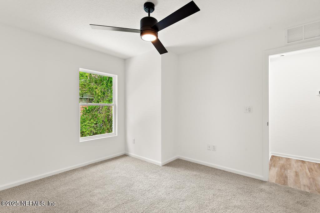 7845 Pipit Avenue Jacksonville, FL 32219 - Photo 25 of 38 an empty room with a window and a ceiling fan