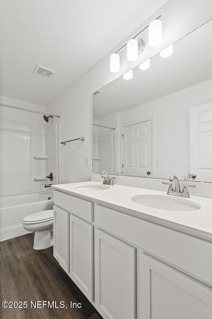 7845 Pipit Avenue Jacksonville, FL 32219 - Photo 28 of 38 a bathroom with a sink a toilet and a mirror