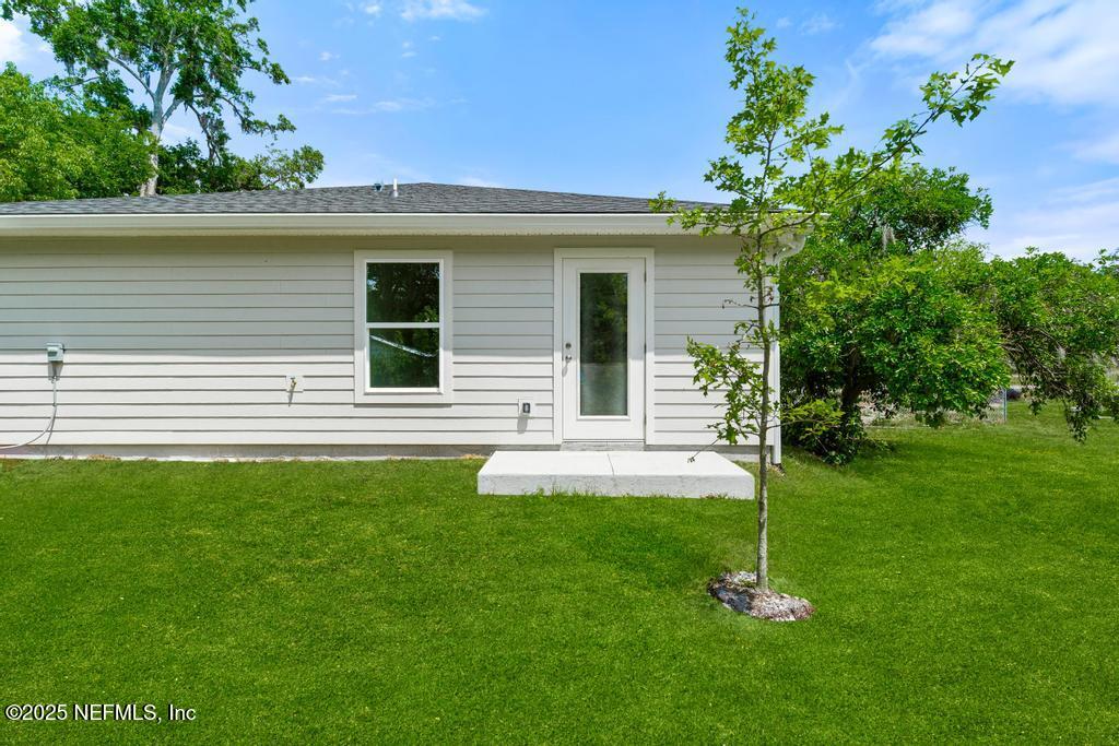 7845 Pipit Avenue Jacksonville, FL 32219 - Photo 35 of 38 a front view of a house with a garden