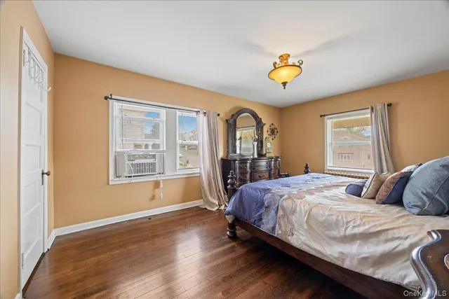 a bedroom with a bed a dresser and a window