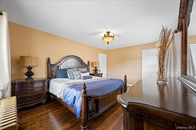 a bedroom with a bed and painting on the wall