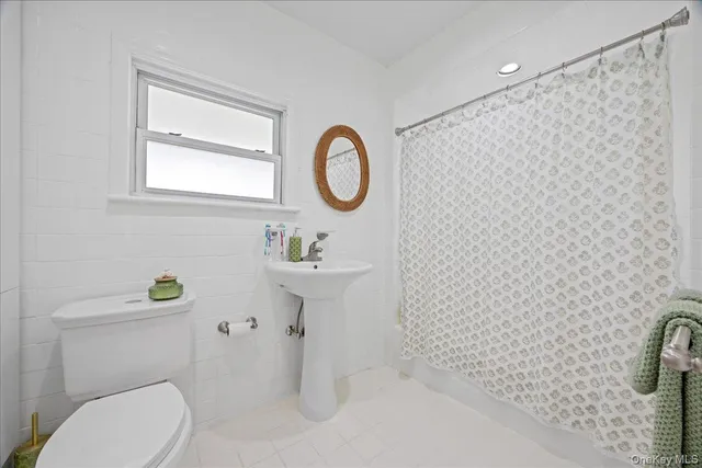 a bathroom with a sink toilet and a mirror