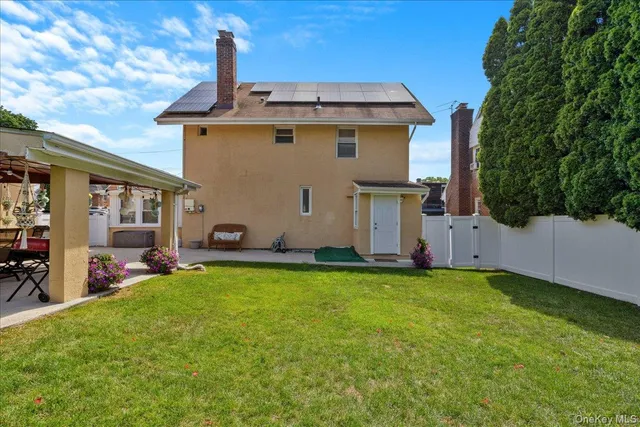 a view of a house with backyard sitting area and garden