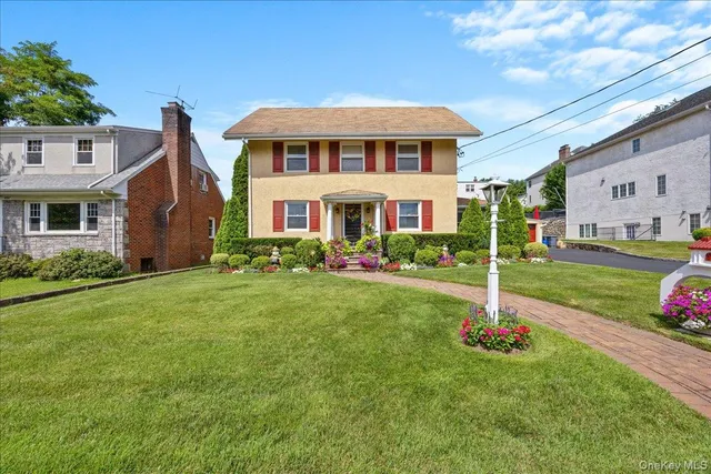 a front view of a house with garden