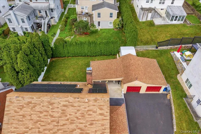 an aerial view of residential houses with outdoor space and trees