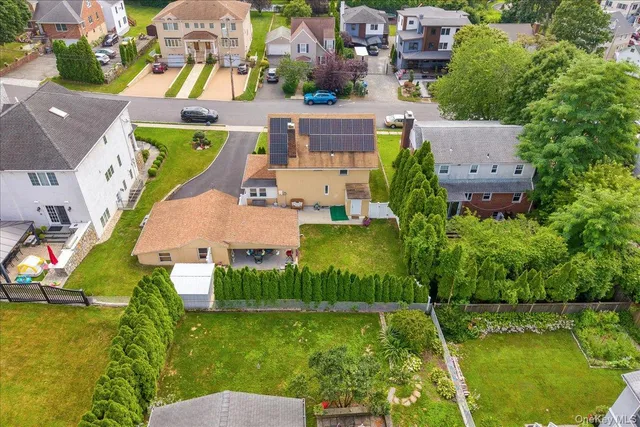 an aerial view of residential houses with outdoor space and swimming pool