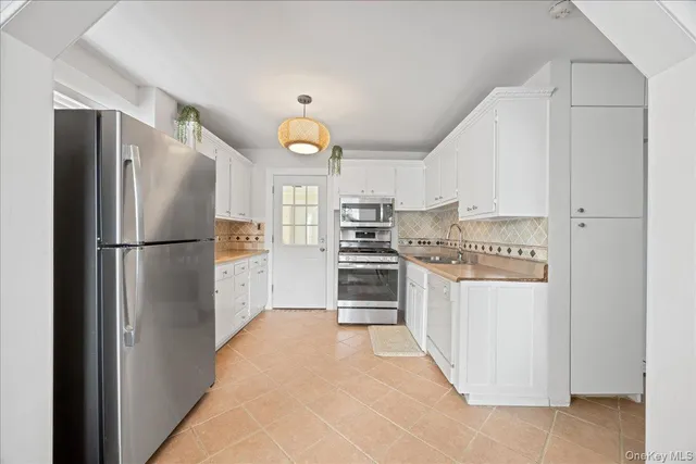 a kitchen with stainless steel appliances a refrigerator and a stove