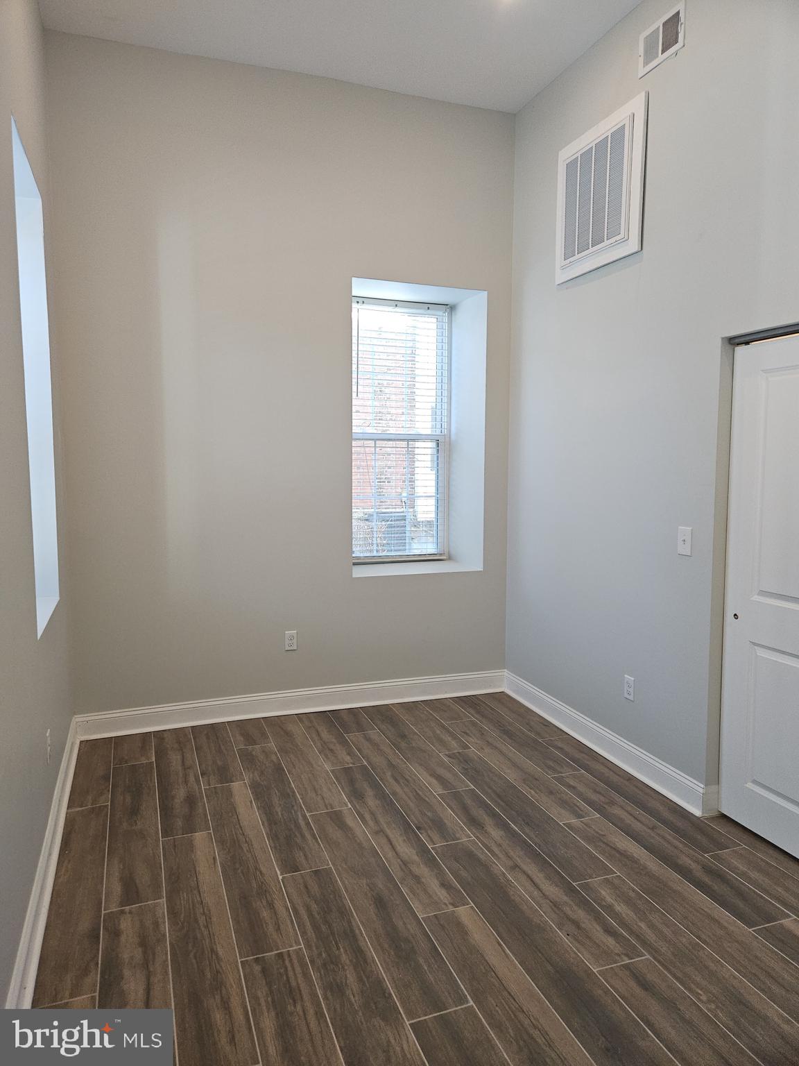59 High Street, Unit A Philadelphia, PA 19144 - Photo 13 of 26 an empty room with wooden floor and windows
