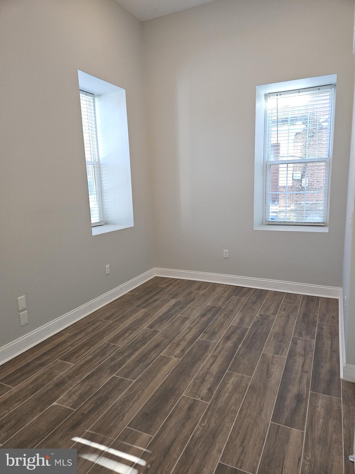 59 High Street, Unit A Philadelphia, PA 19144 - Photo 14 of 26 an empty room with wooden floor and windows