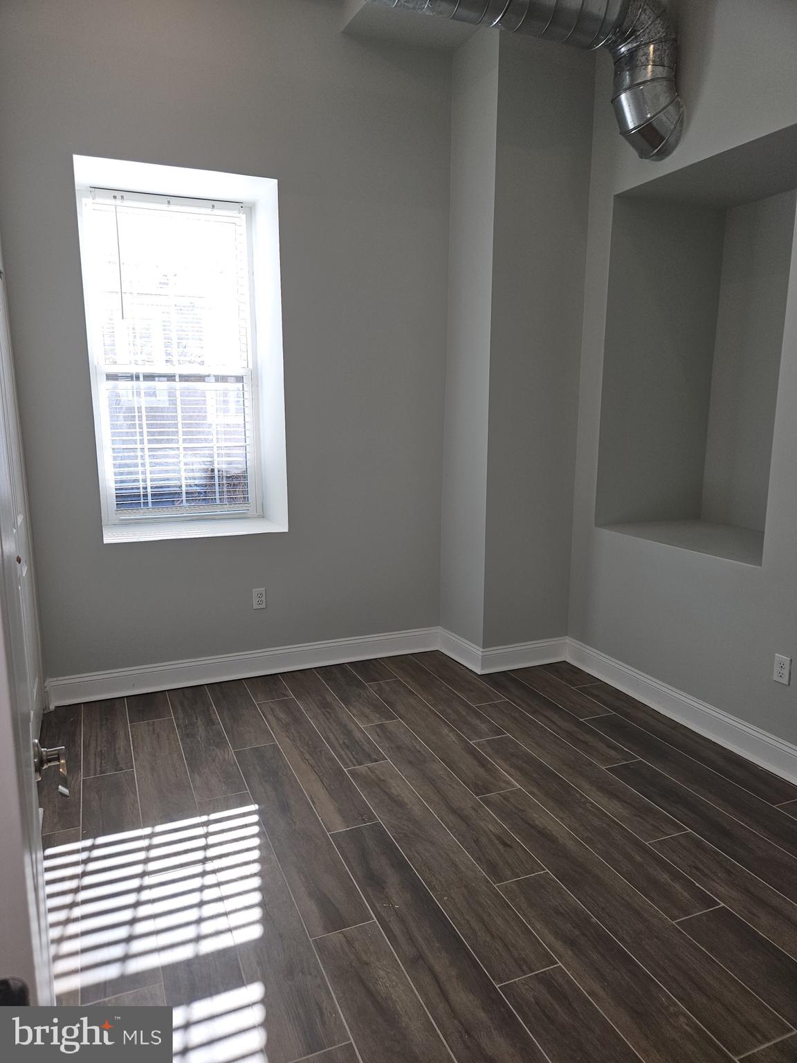 59 High Street, Unit A Philadelphia, PA 19144 - Photo 20 of 26 an empty room with wooden floor and windows