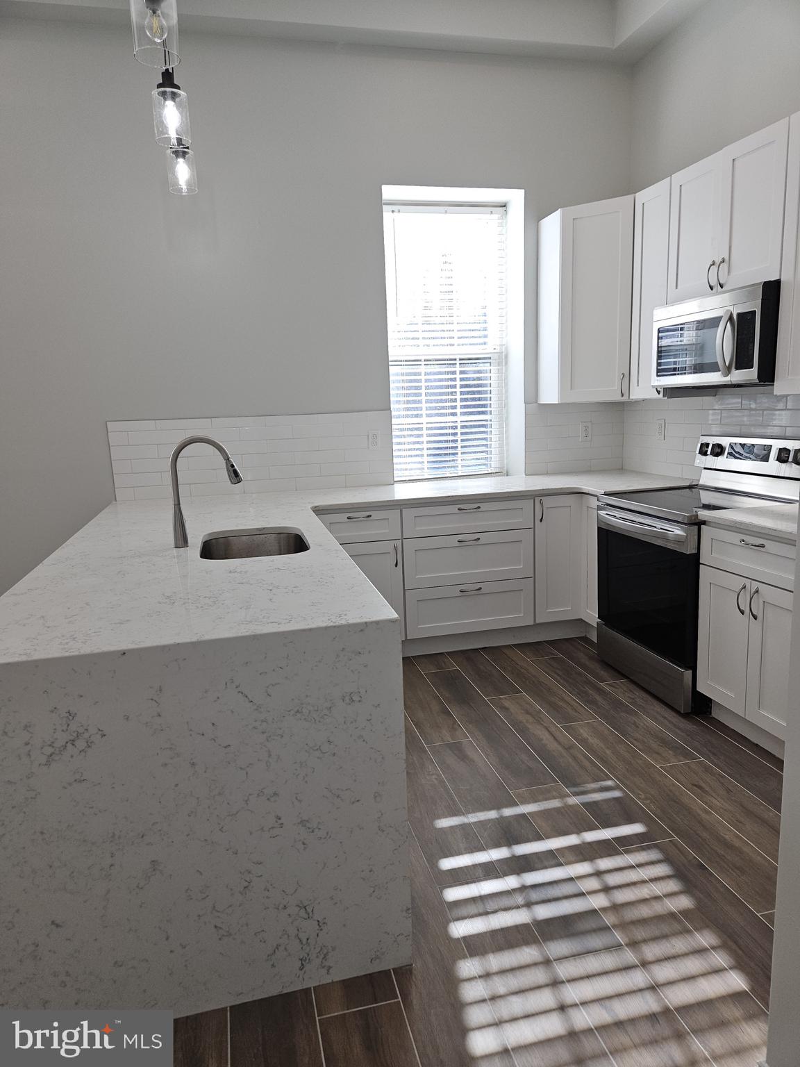 59 High Street, Unit A Philadelphia, PA 19144 - Photo 4 of 26 a kitchen with stainless steel appliances granite countertop a sink stove and microwave