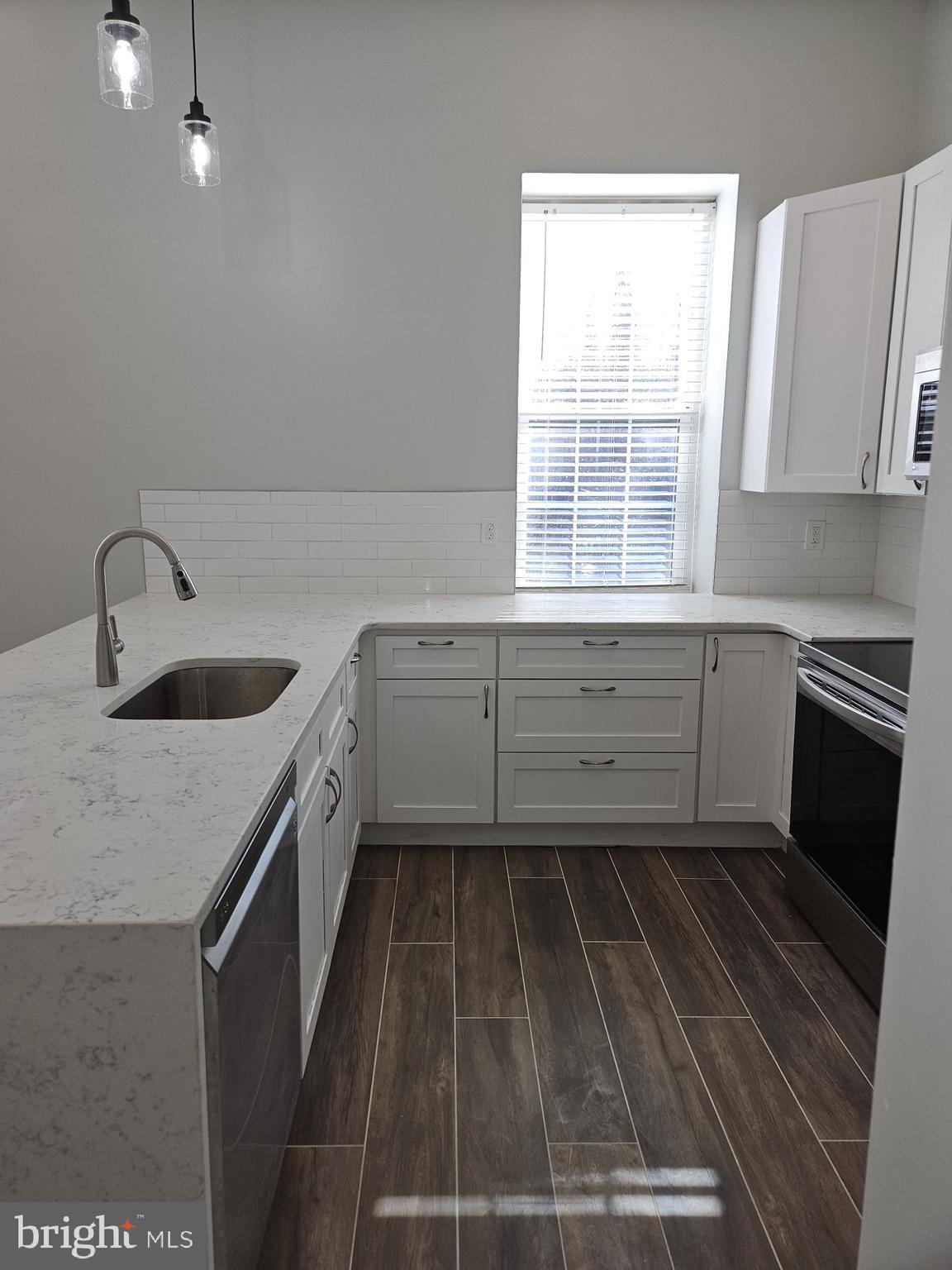 59 High Street, Unit A Philadelphia, PA 19144 - Photo 5 of 26 a kitchen with sink cabinets and window