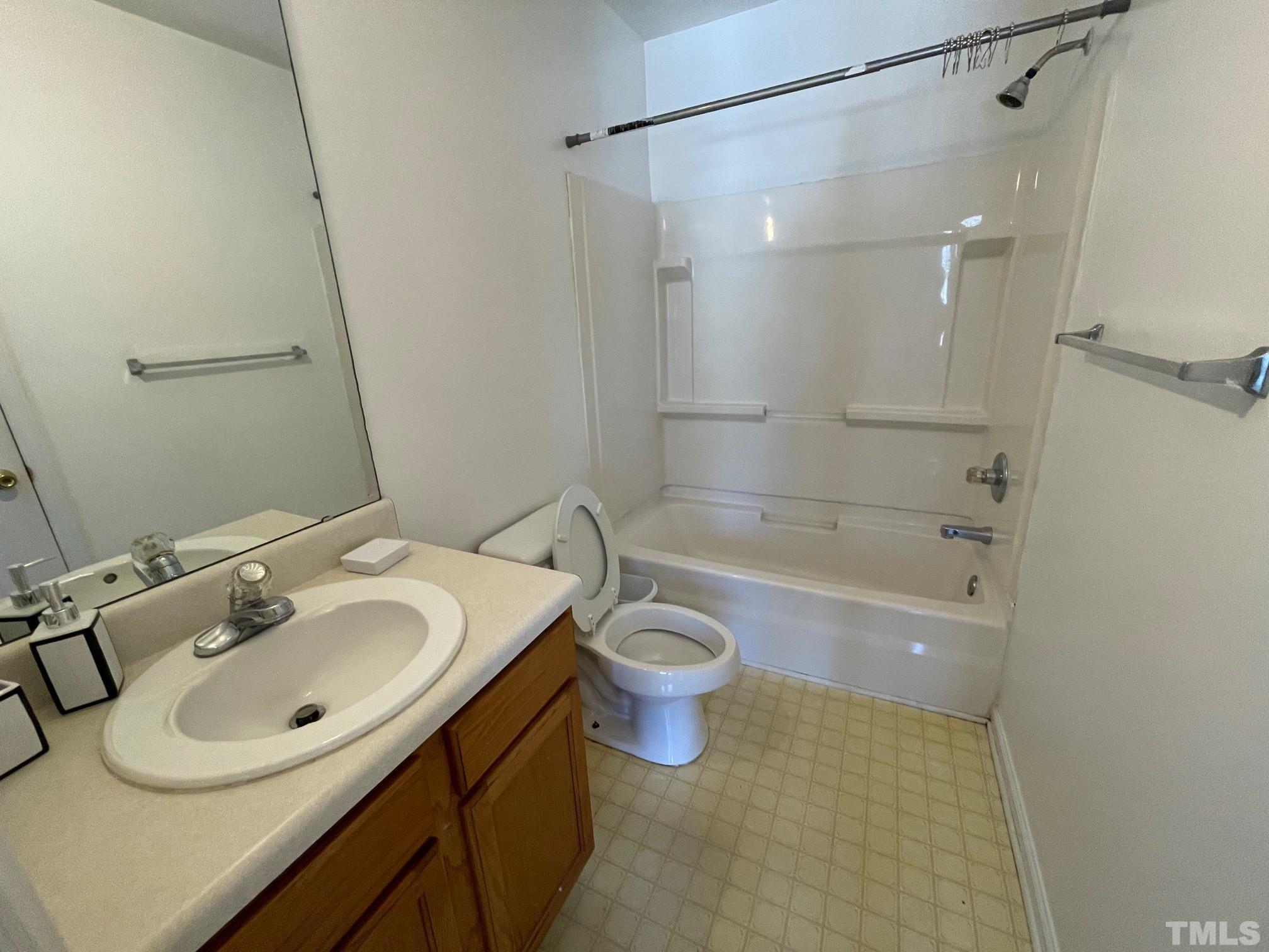 4631 Ravi Road Raleigh, NC 27604 - Photo 14 of 18 a bathroom with a sink toilet and shower
