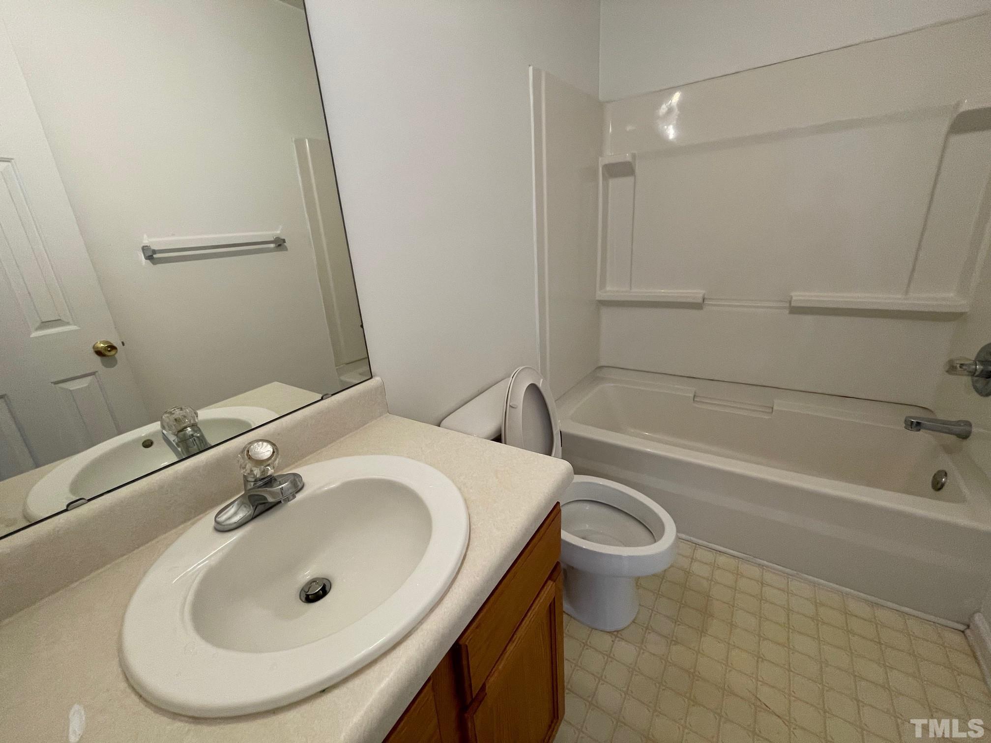 4631 Ravi Road Raleigh, NC 27604 - Photo 16 of 18 a bathroom with a sink a toilet and a bathtub
