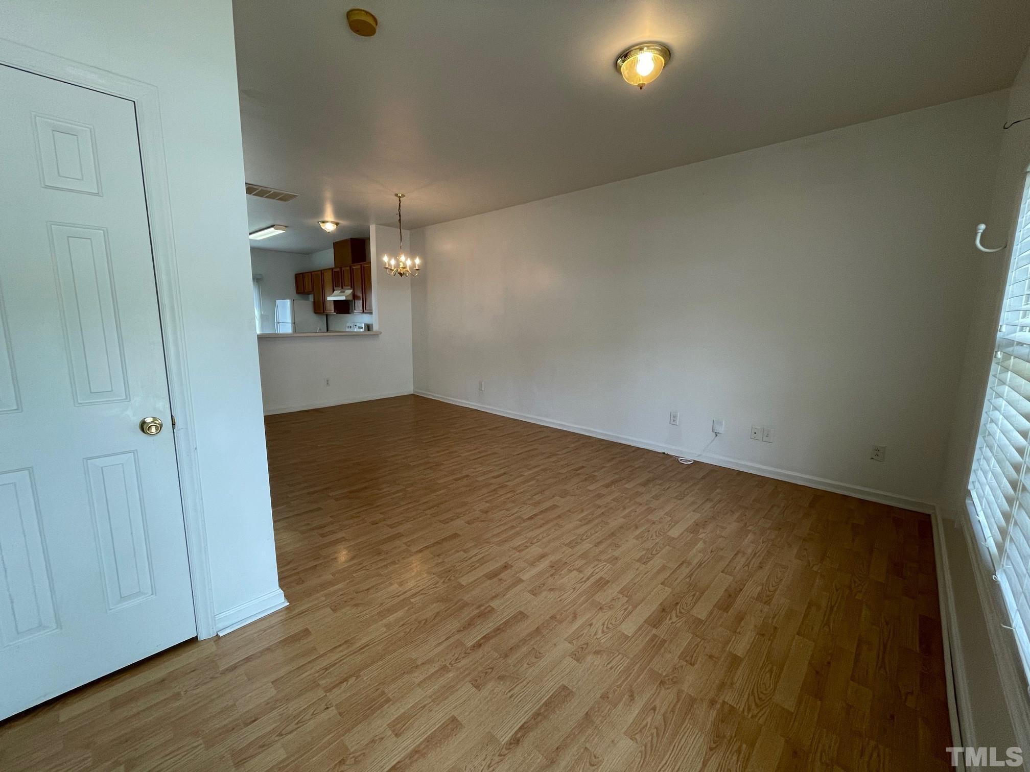 4631 Ravi Road Raleigh, NC 27604 - Photo 5 of 18 wooden floor in an empty room with a window