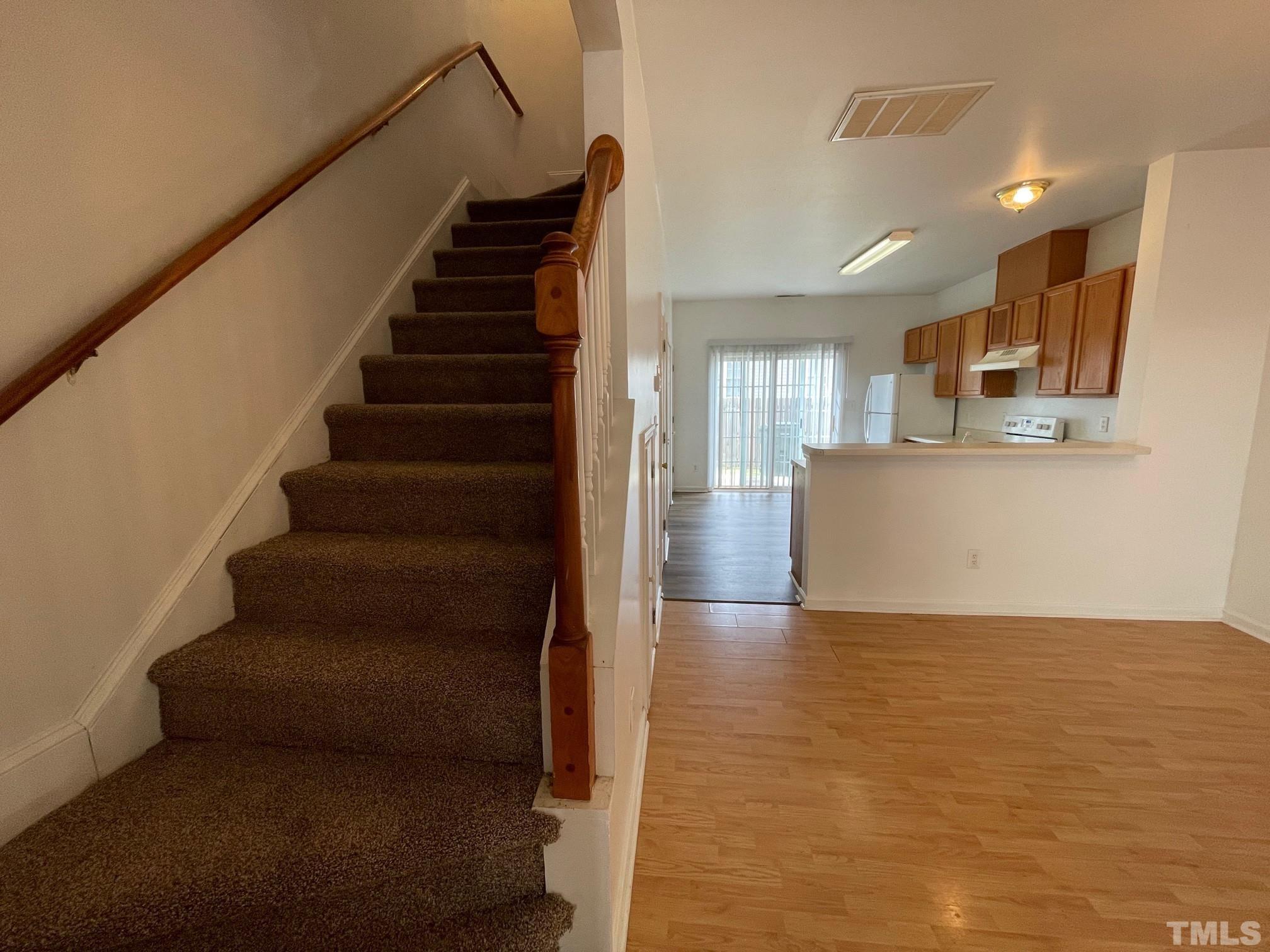 4631 Ravi Road Raleigh, NC 27604 - Photo 9 of 18 a view of kitchen and hall with wooden floor