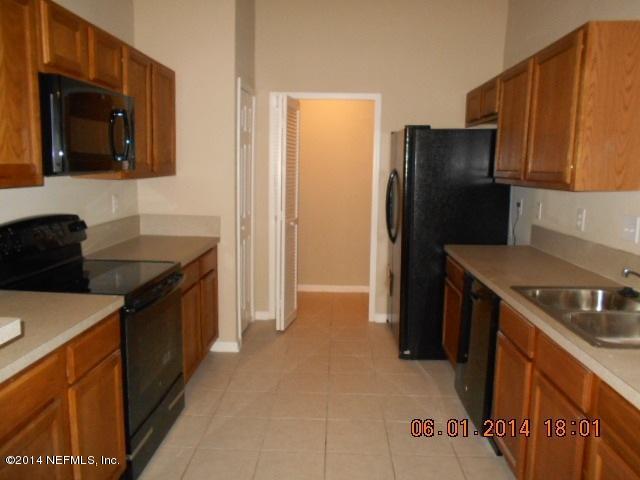 7920 Merrill Road, Unit 614 Jacksonville, FL 32277 - Photo 1 of 5 a kitchen with a refrigerator sink and stove