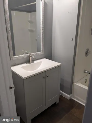 a bathroom with a sink and mirror