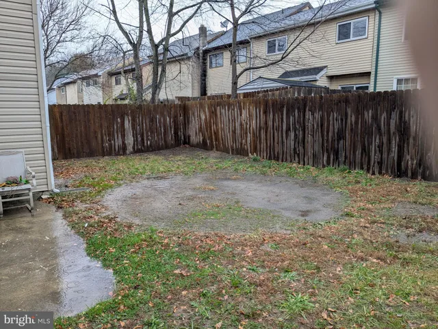 a backyard of a house with green landscape