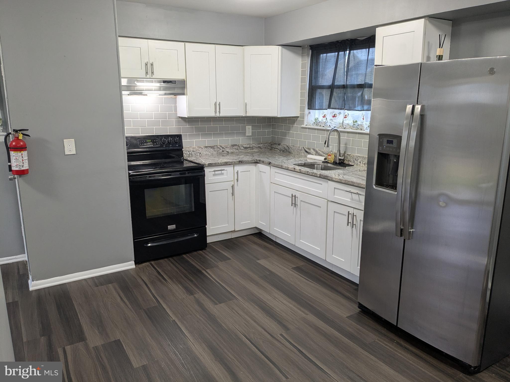 51 Noble Road Sicklerville, NJ 08081 - Photo 3 of 27 a kitchen with stainless steel appliances a refrigerator sink and stove