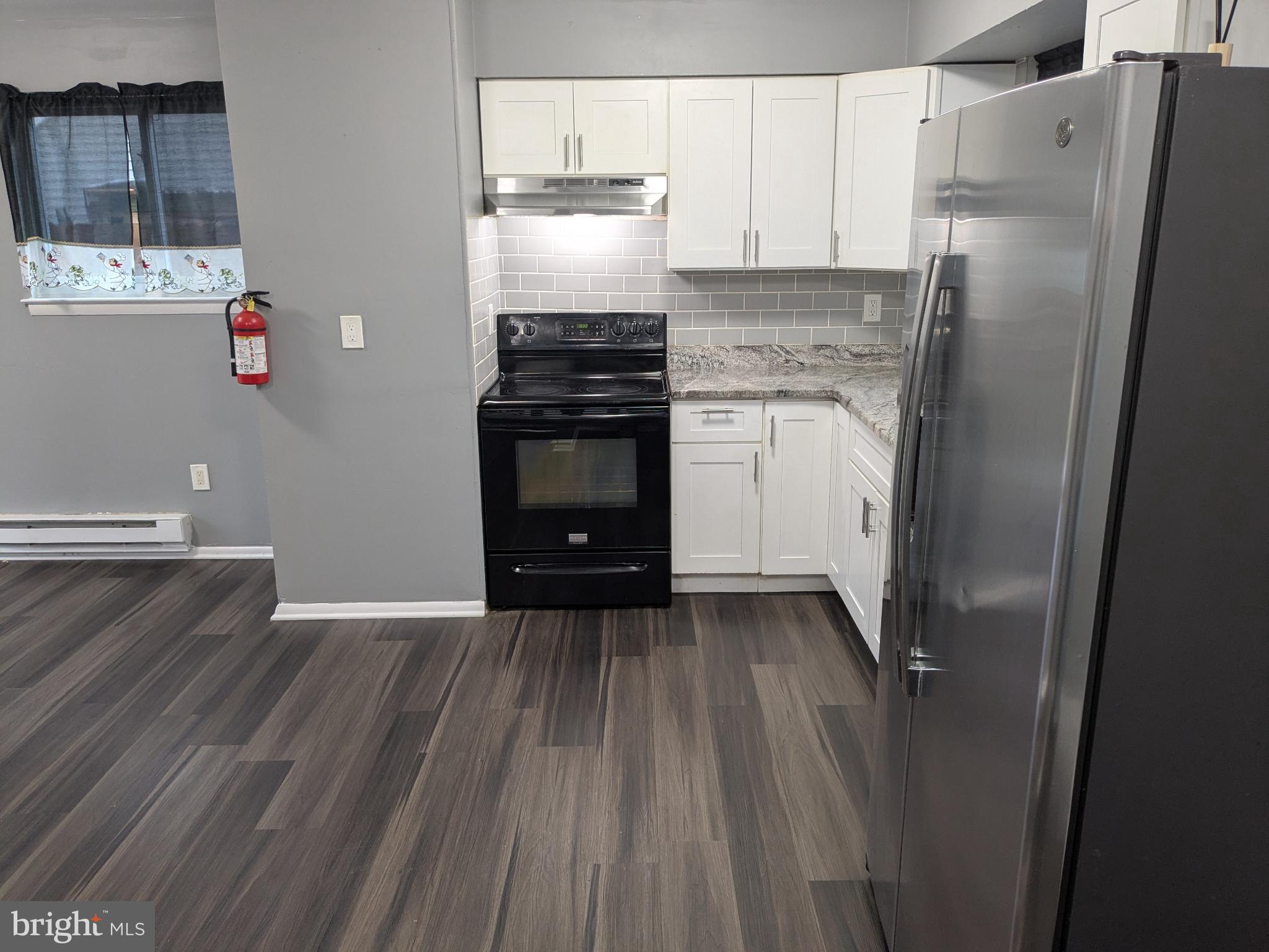 51 Noble Road Sicklerville, NJ 08081 - Photo 5 of 27 a kitchen with granite countertop a refrigerator and a stove