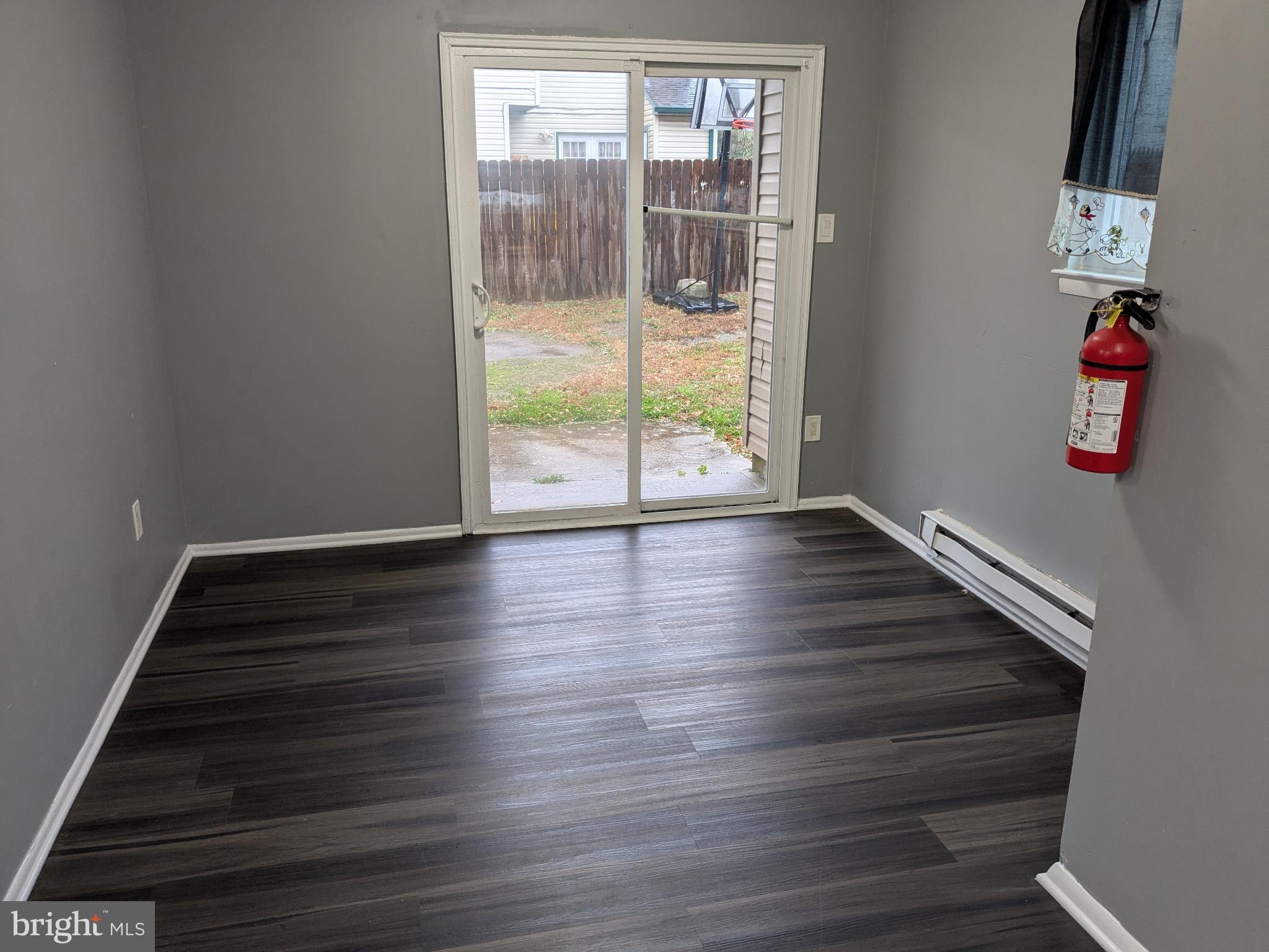 51 Noble Road Sicklerville, NJ 08081 - Photo 7 of 27 a view of an empty room with wooden floor and a window