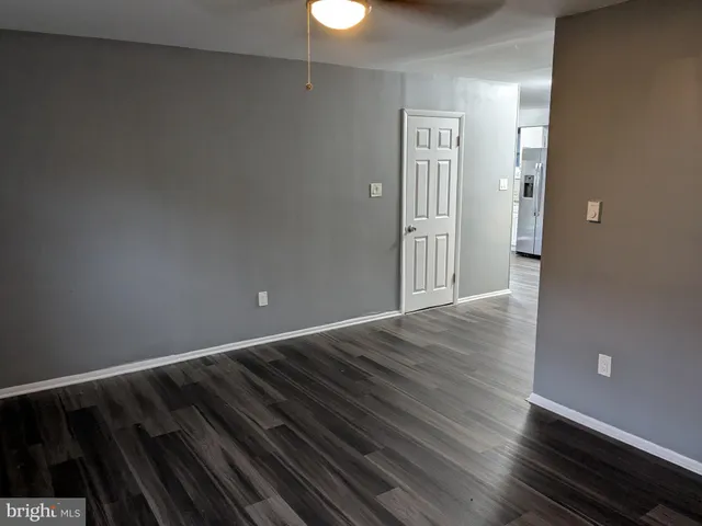 a view of an empty room and wooden floor