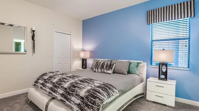 a bedroom with a bed and a lamp