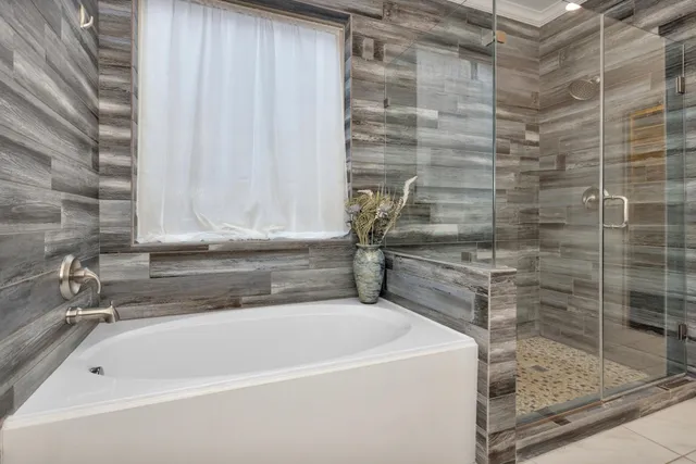 a bathroom with a granite countertop sink a toilet a mirror and bathtub