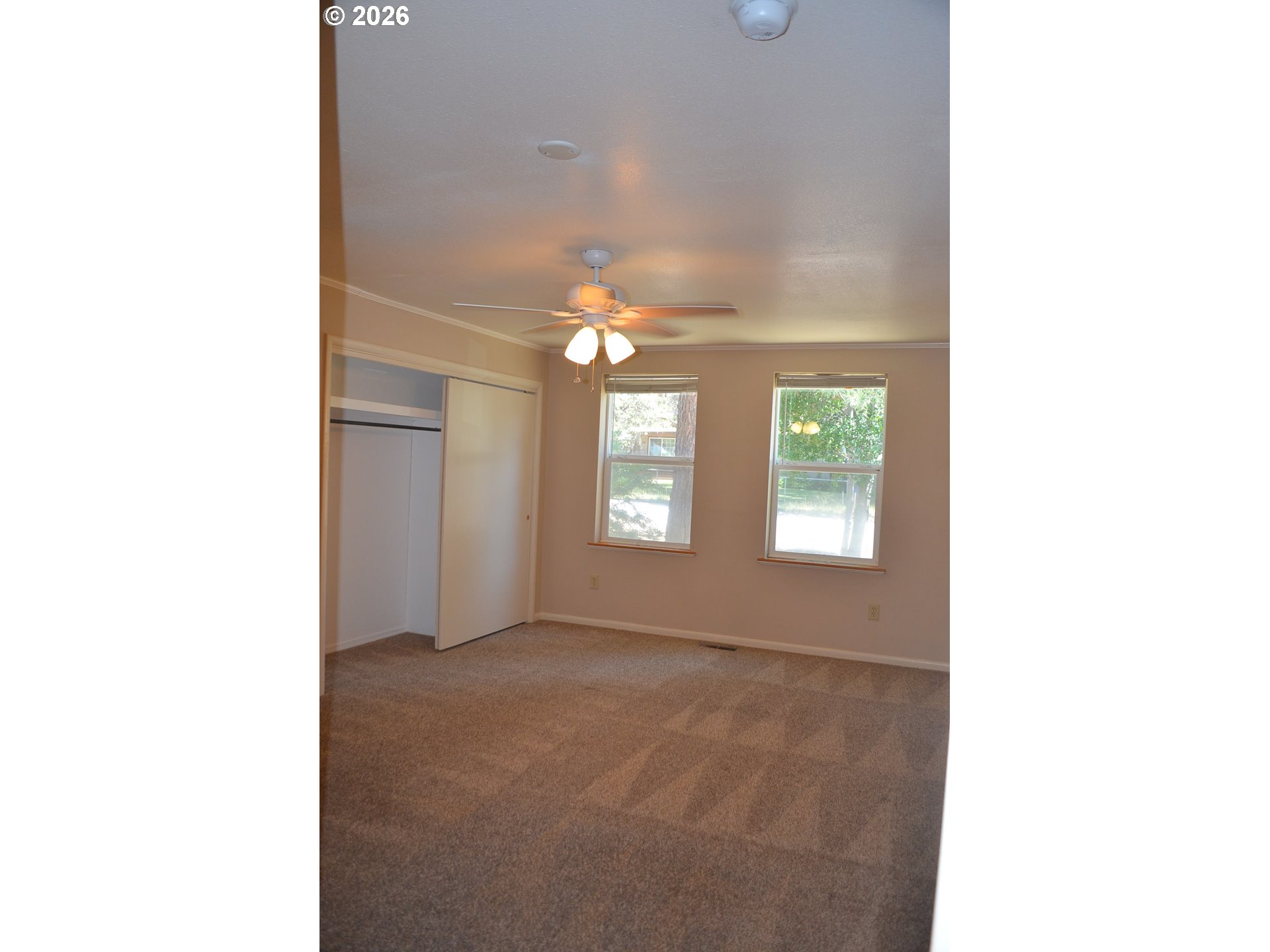 137008 Main Street Crescent, OR 97733 - Photo 21 of 47 a view of an empty room with window and chandelier fan