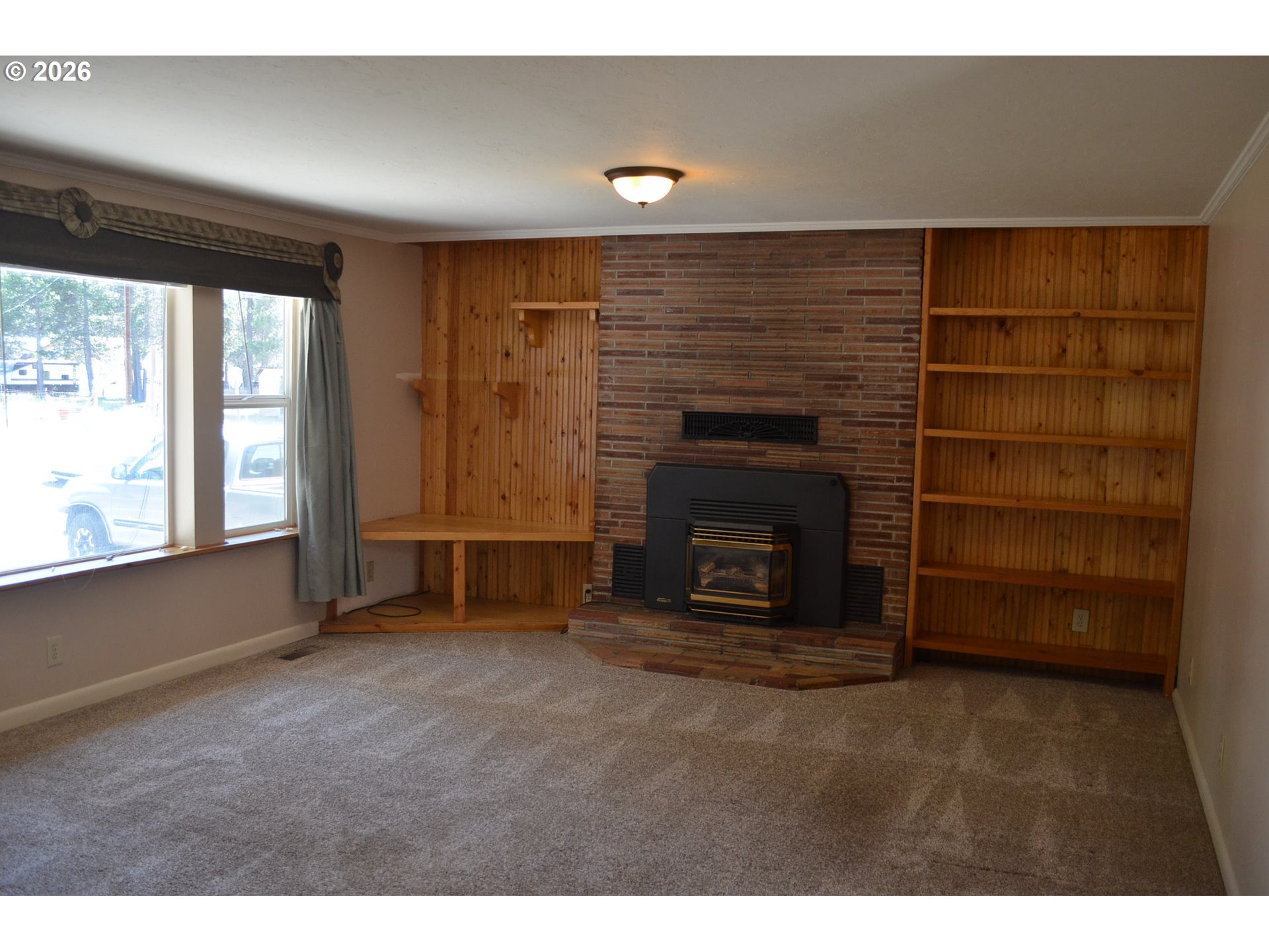 137008 Main Street Crescent, OR 97733 - Photo 4 of 47 a view of an empty room with a fireplace and window