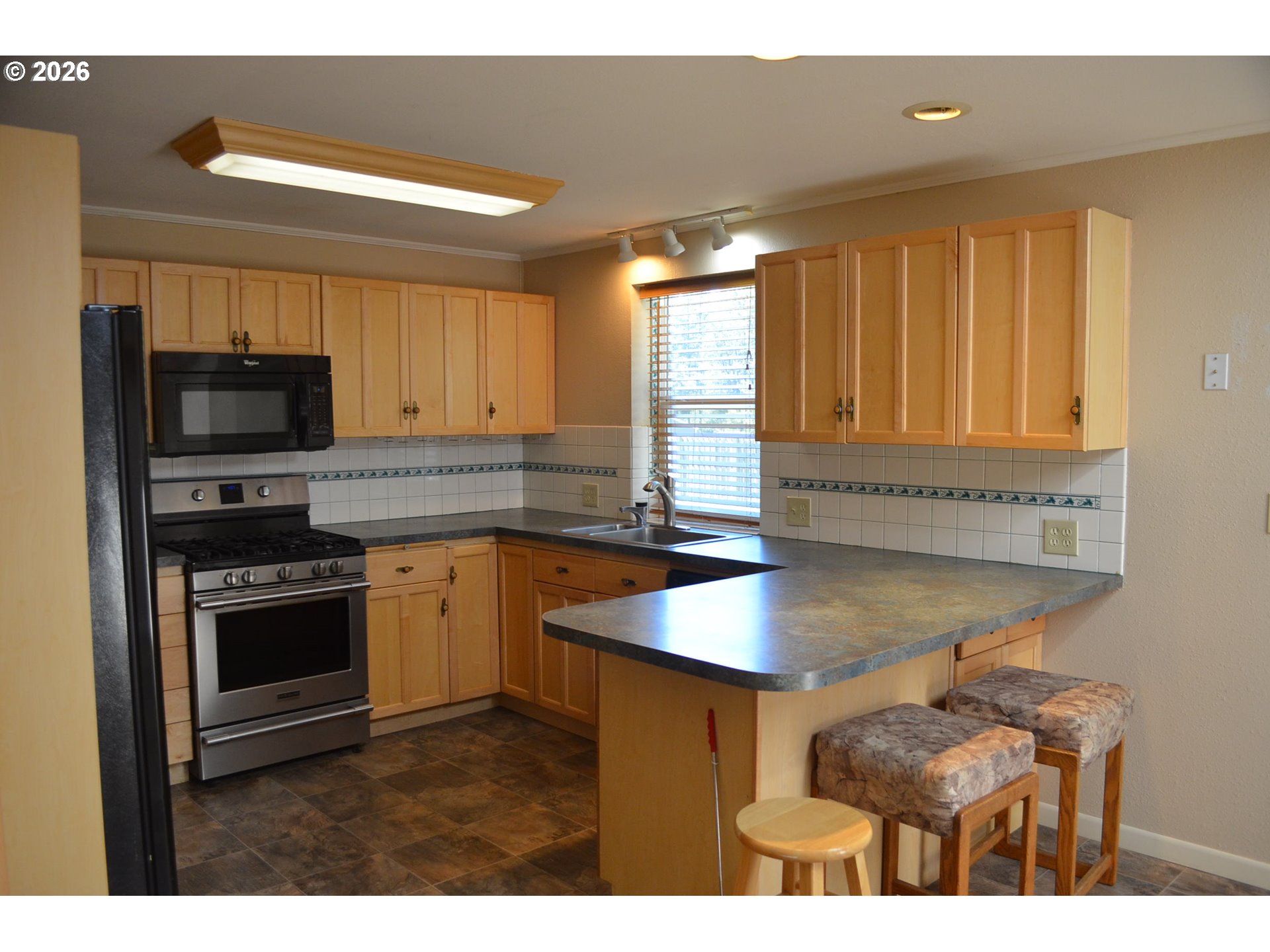 137008 Main Street Crescent, OR 97733 - Photo 6 of 47 a kitchen with stainless steel appliances granite countertop a stove a sink and a microwave