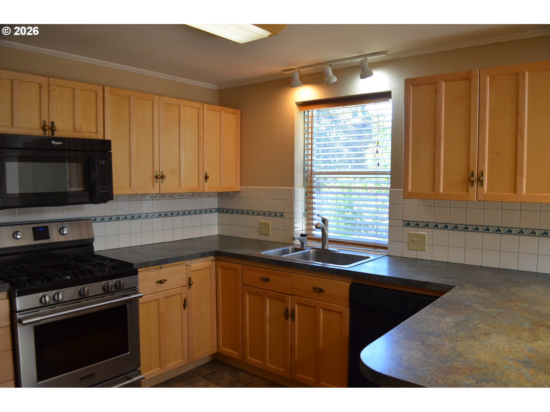 137008 Main Street Crescent, OR 97733 - Photo 7 of 47 a kitchen with granite countertop a sink stainless steel appliances and cabinets
