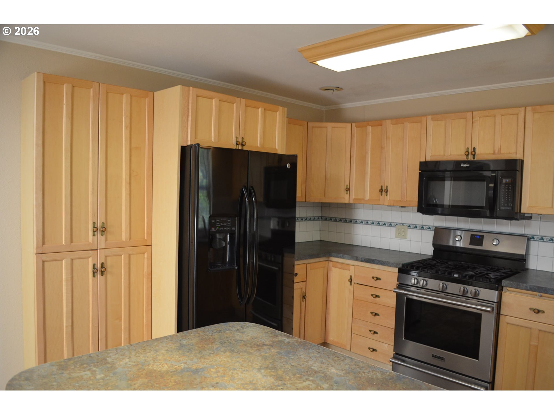 137008 Main Street Crescent, OR 97733 - Photo 8 of 47 a kitchen with stainless steel appliances granite countertop a refrigerator stove and microwave