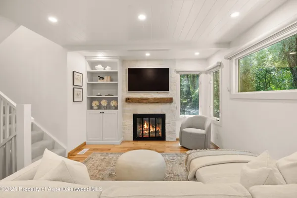 a living room with fireplace furniture and a flat screen tv