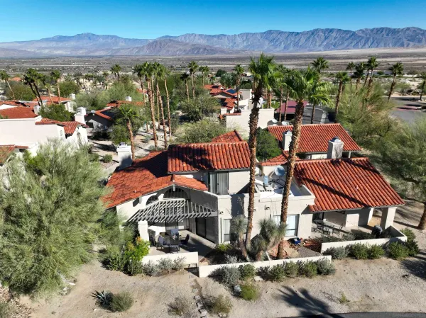 a view of a patio with a table and chairs